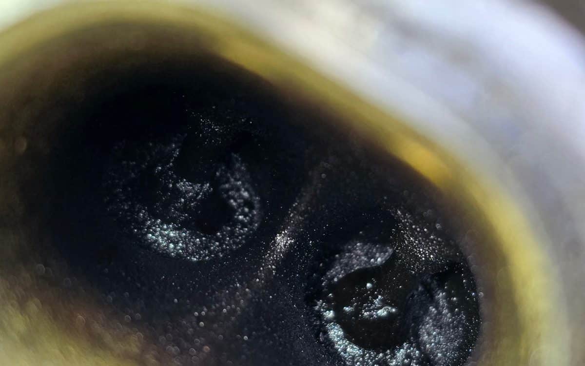 Intake valve with heavy carbon buildup before induction cleaning